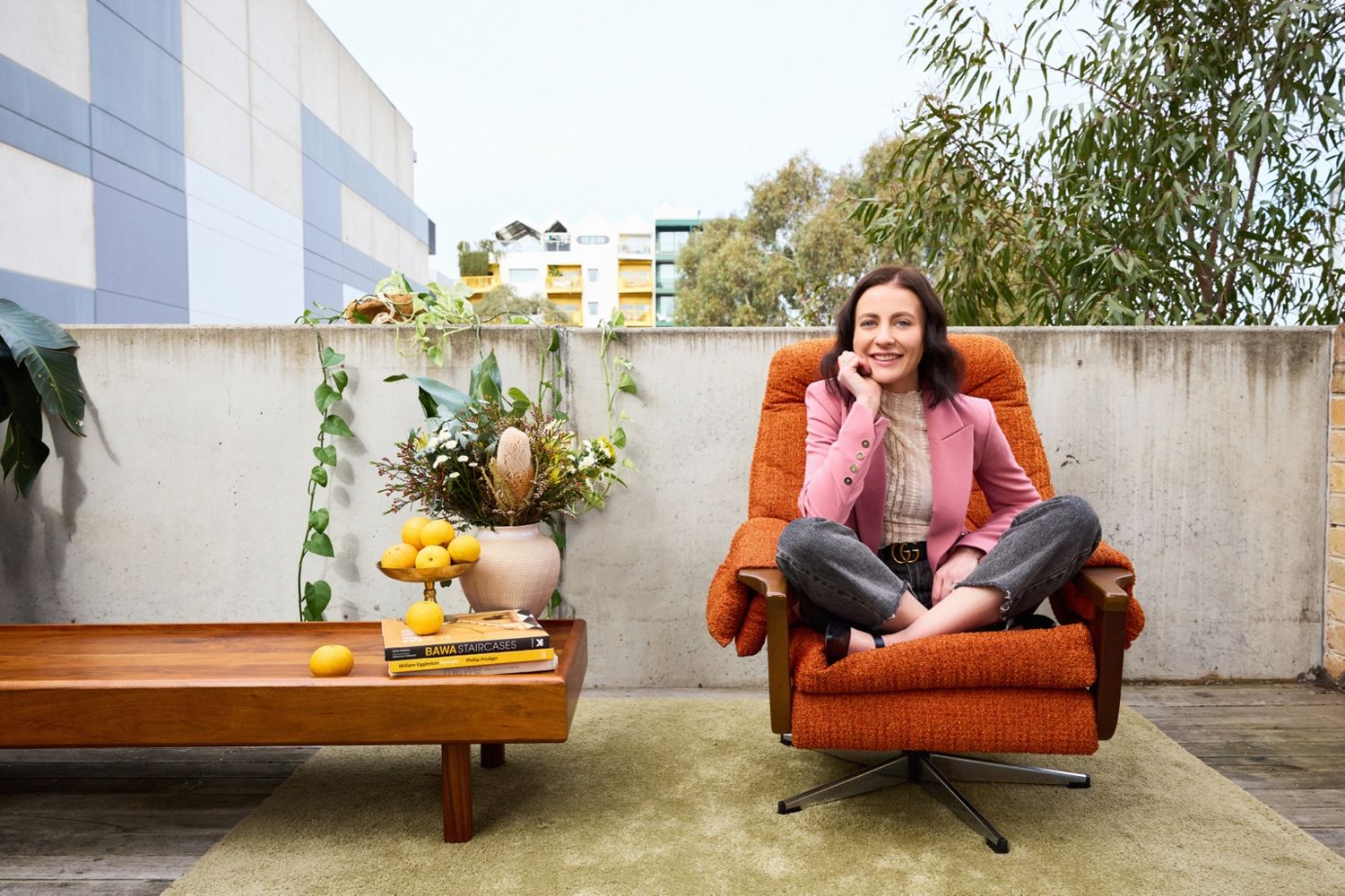 Danielle Boyd, founder of Next Address Co., seated on an outdoor terrace